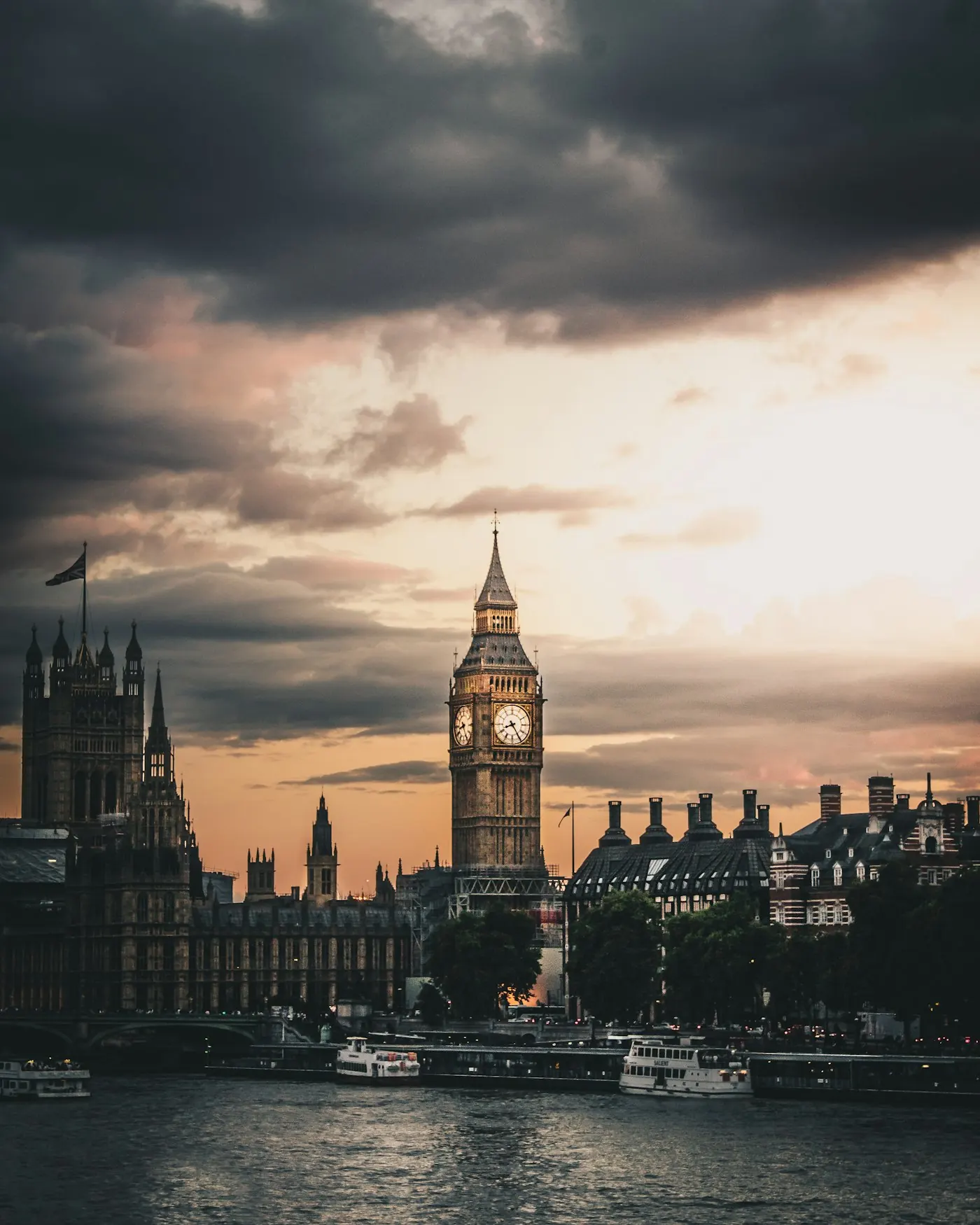 The Palace of Westminster and Elizabeth Tower from the Thames at dusk.