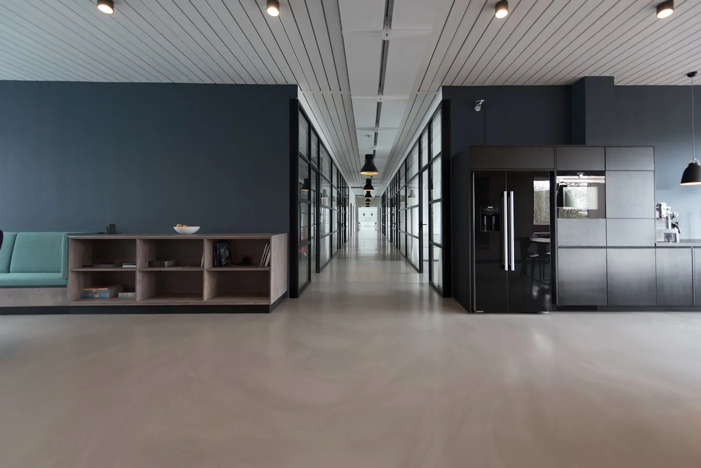 A quiet office floor. The test itself is remote-default; the method is not casual.
