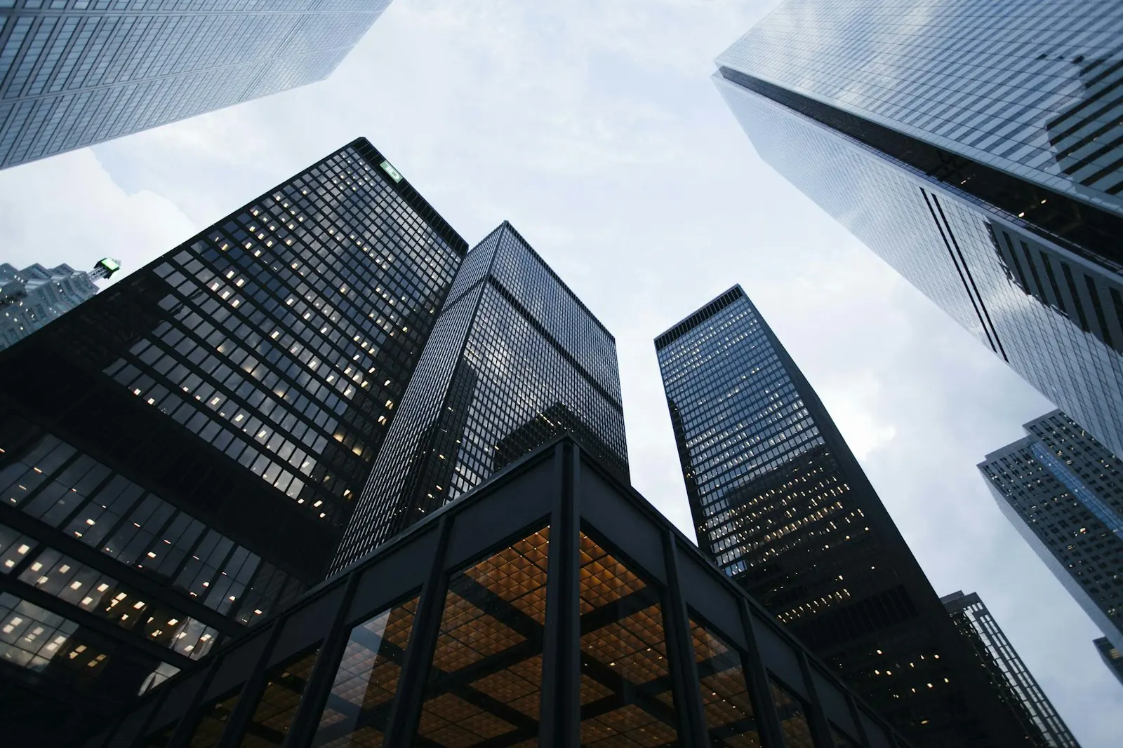 Looking up at commercial towers — the kind of estate a UK buyer asks us to test.